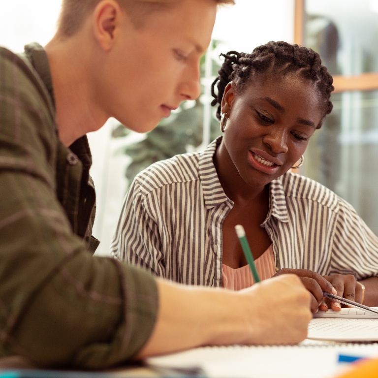 Man and woman working together at a desk.