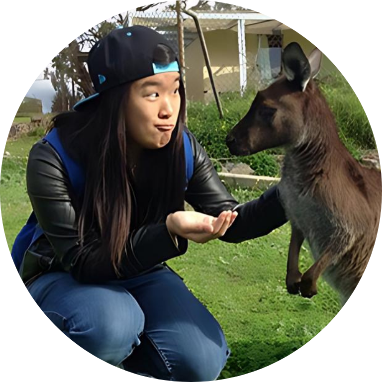 Jessie Chen feeding a kangaroo out of the palm of her hand.