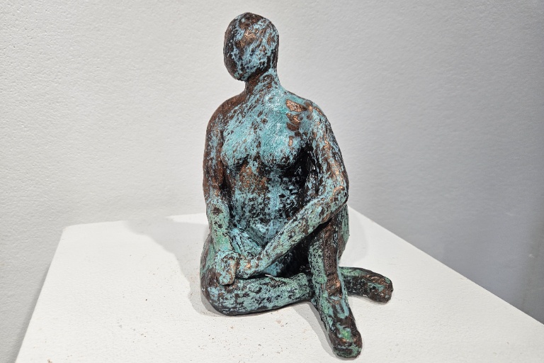 Small ceramic sculpture by Aspen Lyons titled Therapy I. A rustic female nude form with oxidization.