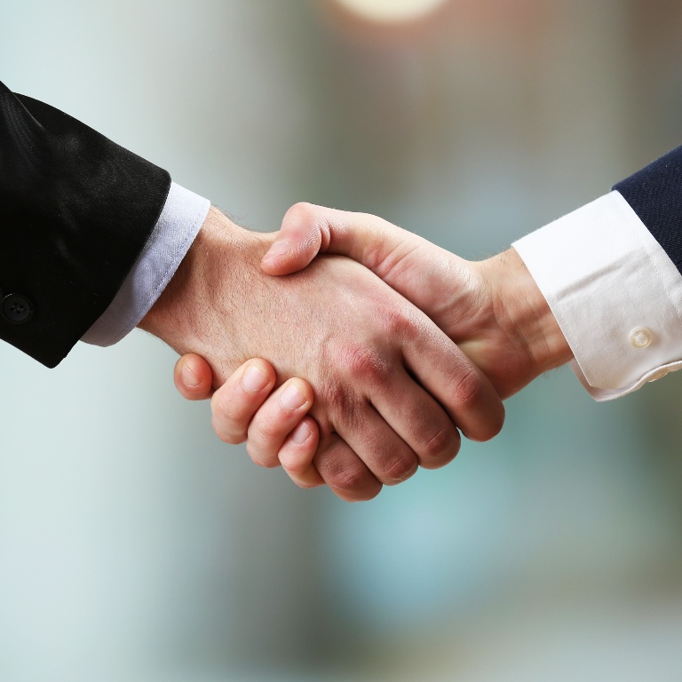 Decorative image of two individuals shaking hands to represent the Handshake app.